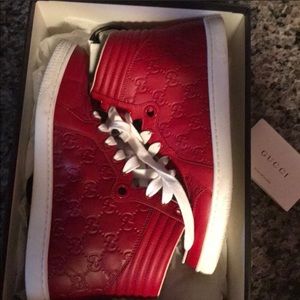 Red Gucci high top tennis shoes